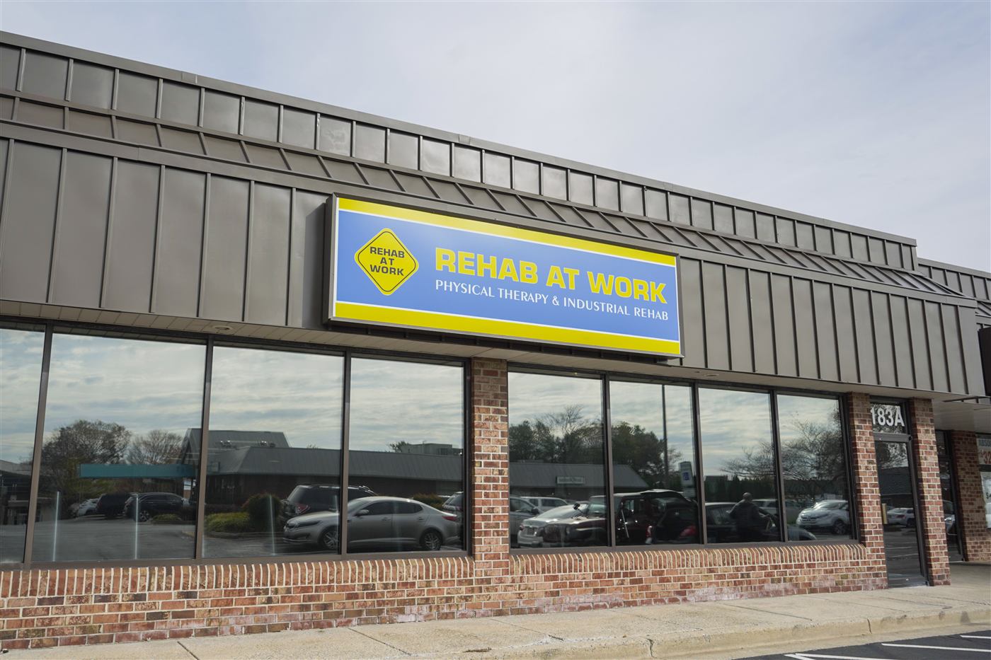 The REHAB AT WORK Frederick clinic storefront with branded signage